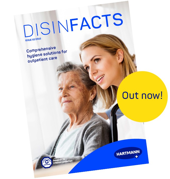 An elderly woman in a wheelchair and a younger woman who bends down attentively