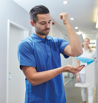 Hand disinfection nurse using Eurodispenser Safety plus in hallway