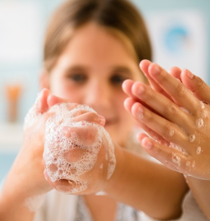 Little girl washing her hands