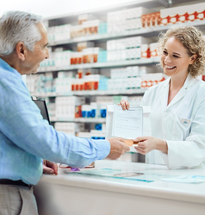 Sales situation in a pharmacy with a pharmacist and an older man with shelves in the background