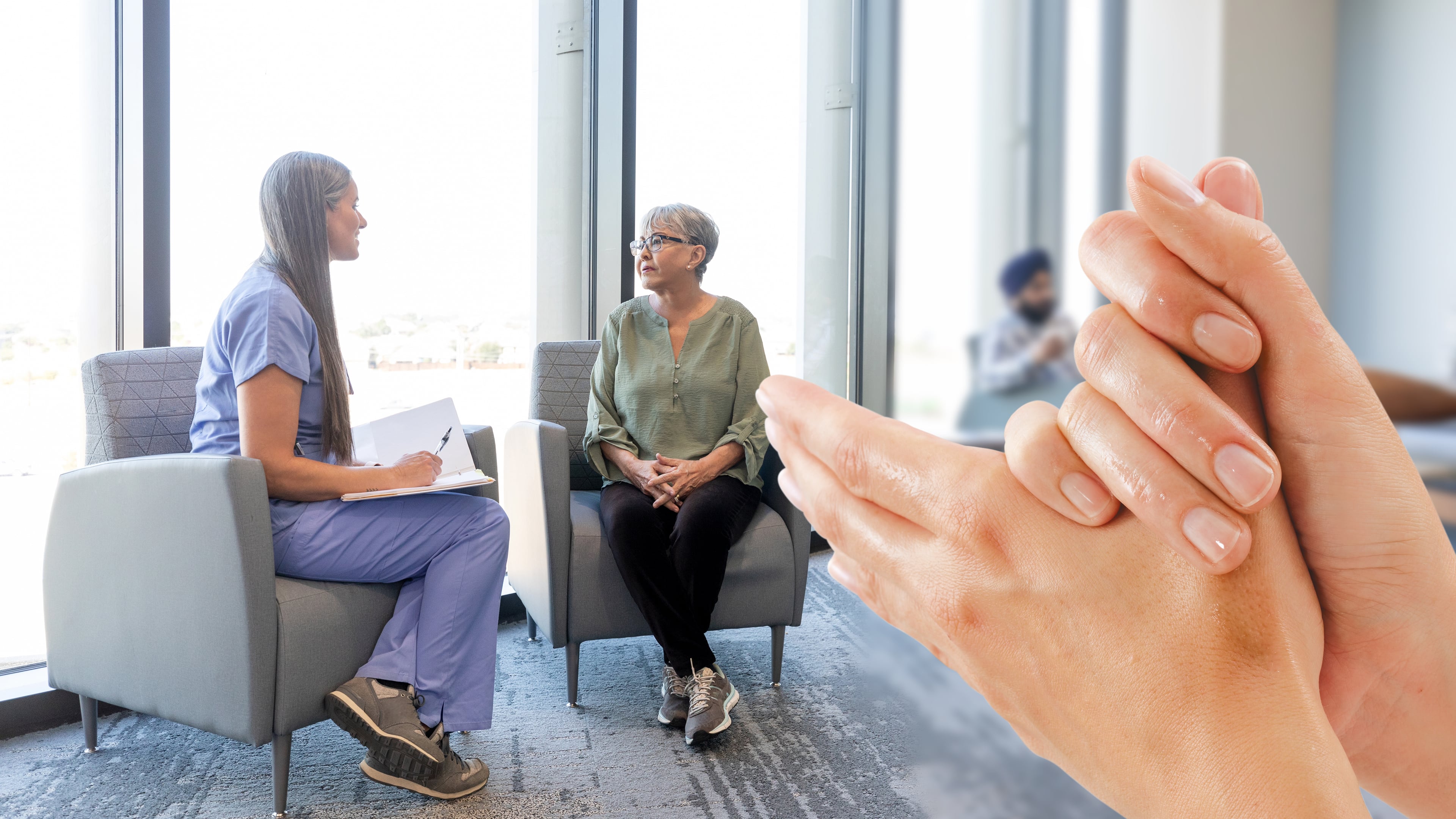 Two women sitting next to each other and two hands in the front doing hand disinfection