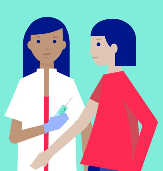 Two healthcare professionals stand together, one holding a syringe, illustrating vaccination or injection care in a clinical context.